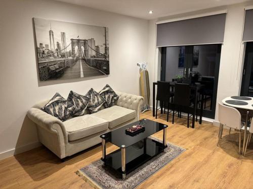a living room with a couch and a table at Bedroom 2 in Elegant 3 Bed Flat in Ramsgate in Kent