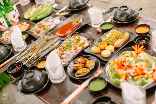 a table with many plates of food on it at LALASEA BISTRO (Camping, Food & Drink) in Ha Tien