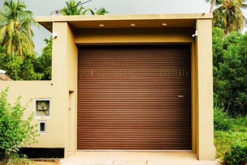 a large garage door in the side of a house at Villa Andaz in Negombo