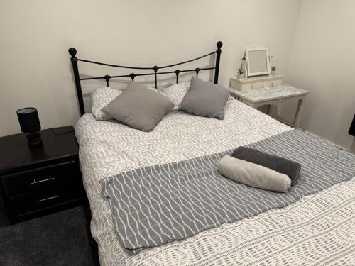 a bedroom with a bed with two pillows on it at Bedroom 3 in Elegant 3 Bed Flat in Ramsgate in Kent