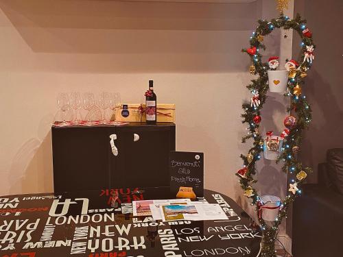 a room with a christmas tree and a table with wine glasses at FRESH HOME in Turin