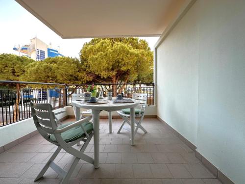 a balcony with a table and chairs on a patio at Residenza Porta Del Mare in Lignano Sabbiadoro
