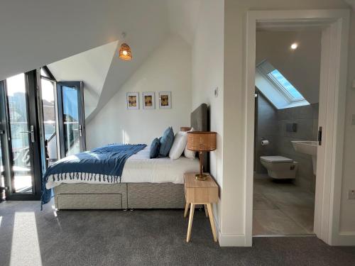 a bedroom with a bed and a bathroom at Exceptional 3 bedroom home in Penzance~New~Seaside in Penzance