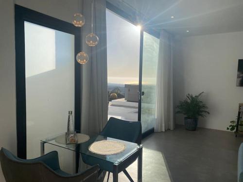 a living room with a table and chairs and a bedroom at private loft-sea views-Jacuzzi in La Asomada