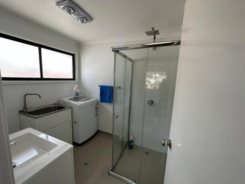 a bathroom with a shower and a sink at Peak View in Lithgow