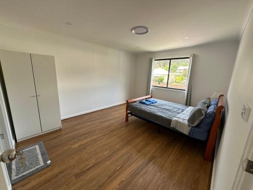 an empty room with a bed and a window at Peak View in Lithgow