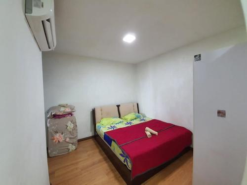 a bedroom with a bed in a white room at Bunny Homestay 408 @ Roxy Apartment Kuching in Kuching