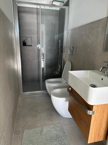 a bathroom with a toilet and a sink and a shower at Casa al Prino in Imperia
