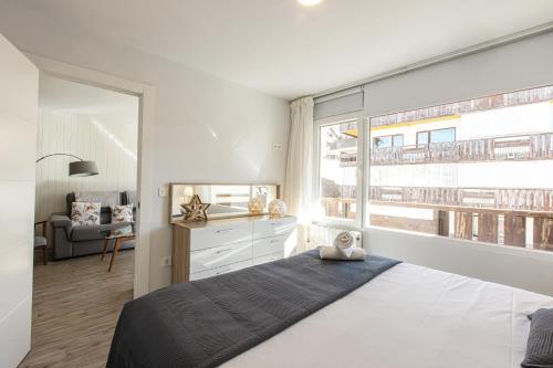 シエラネバダにあるHolidays, Tripp, 1 dormitorio, 4 personas, Terrazaのベッドと大きな窓のある寝室