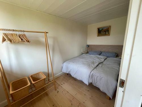 a small bedroom with a bed in a room at Wildernest Bornholm in Neksø