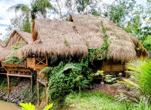 atropical house with a thatched roof at Banteay Srey Women's Only Traditional Spa and Homestay in Kampot