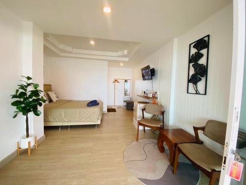 um quarto com uma cama, um sofá e uma mesa em บ้านพักการ์ฟิลด์ ซีวิว เกาะล้าน em Ko Larn