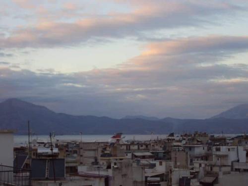 a view of a city with buildings and the water at Urban Penthouse in Patra