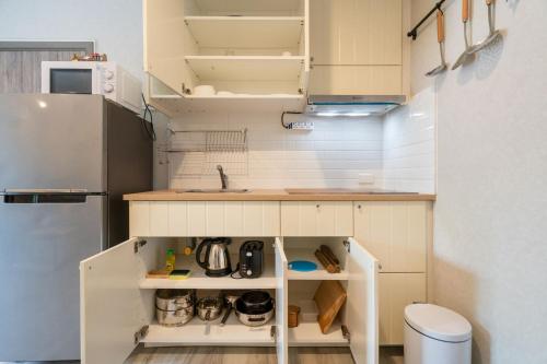 a small kitchen with a sink and a refrigerator at F11 Title 50м2 Люкс Бассейн Рубль ВАТСАП669З582I976 in Nai Yang Beach