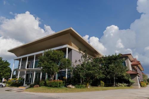 a building in front of a parking lot at Southern Airport Hotel Hatyai in Hat Yai