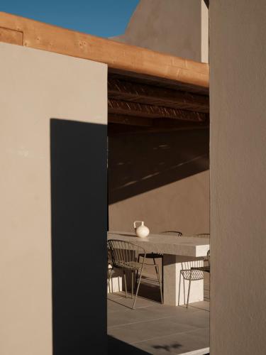 a dining room with a table and chairs at Ethos Retreat Imerovigli, Santorini in Imerovigli