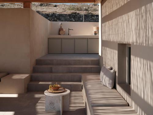 a room with stairs with a table and a sink at Ethos Retreat Imerovigli, Santorini in Imerovigli