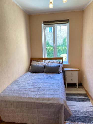 a bedroom with a bed and a window at Cosy 2 room 55m2 Centric 10min to Old Town AC in Rīga