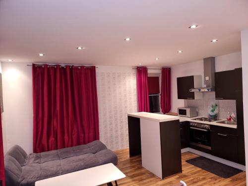 a living room with red curtains and a couch at Rentcenter79_2 in Sankt Michael in Obersteiermark