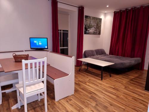a living room with a desk and a table and a couch at Rentcenter79_2 in Sankt Michael in Obersteiermark