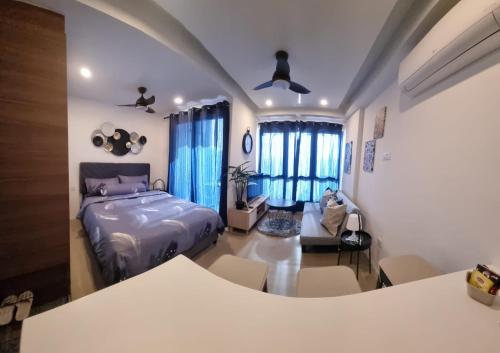 a bedroom with a bed and a living room at HarbourBay Residence. Batam. Studio. 1min to Ferry in Jodoh