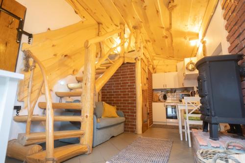 a living room with a spiral staircase in a tiny house at CHILL Village - Osikowy Apartament in Nowinka