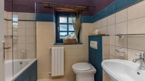a bathroom with a toilet and a sink and a tub at Le Château in Višnjan