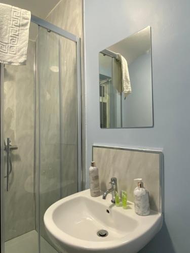 a bathroom with a sink and a shower at Abbie Lodge Guest House in Weston-super-Mare