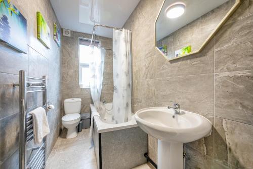 a bathroom with a sink and a toilet at *Rb12s* For your most relaxed & Cosy stay + Free Parking + Free Fast WiFi * in Headingley