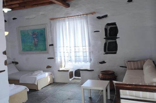 a living room with a couch and a table at Fyrou- Serenity / Idyllic Traditional Experience in Artemonas