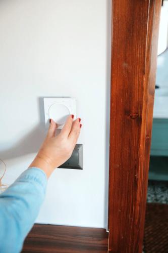 a person unlocking a door with their hand on a lightswitch at Abant Cozy Homes in Bolu