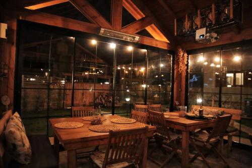 a dining room with a wooden table and chairs at Abant Cozy Homes in Bolu