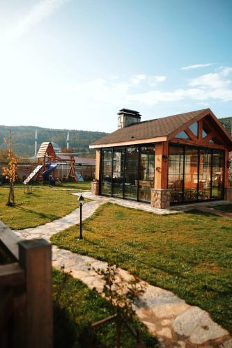a building with a playground in a park at Abant Cozy Homes in Bolu