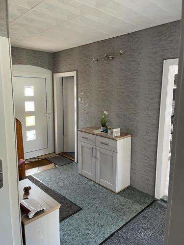 an empty room with a counter in the middle of a room at Ferienhaus Bockswiese in Goslar