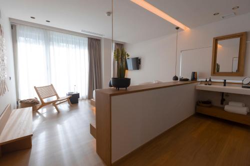 a bathroom with a sink and a counter with a mirror at Malates Slow Boutique Hotel in Foz