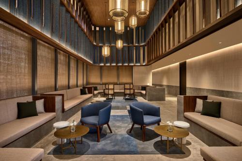 a lobby with couches and chairs and tables at Artyzen NEW BUND 31 Shanghai Qiantan in Shanghai