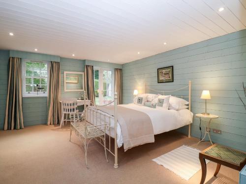 a bedroom with a bed and a table and chairs at Lampland House in Southwold