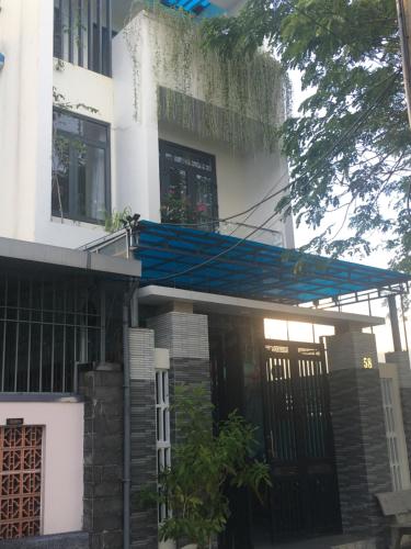 a building with a blue awning in front of it at LA GAI HOMESTAY HOI AN in Hoi An