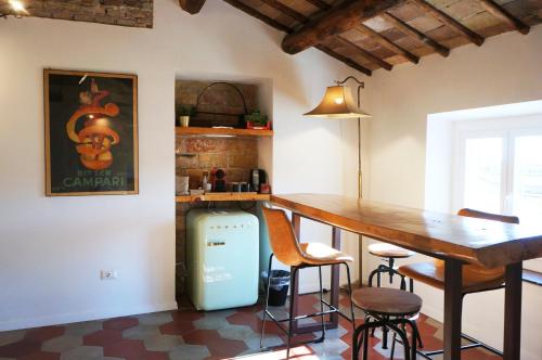 a kitchen with a bar and a table and chairs at THE ROMAN WAY OPERA in Rome