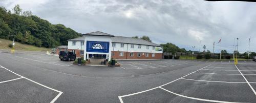 a parking lot with a building with a clock on it at Holiday Inn Express Canterbury by IHG in Canterbury