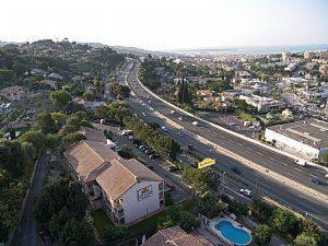 an aerial view of a city with a highway at Hôtel Belvedère Cannes Mougins in Mougins