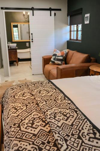 a living room with a bed and a couch at 41 South C in Mtunzini