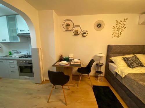 a bedroom with a bed and a table and chairs at Studio Apartment Lacus in Zagreb