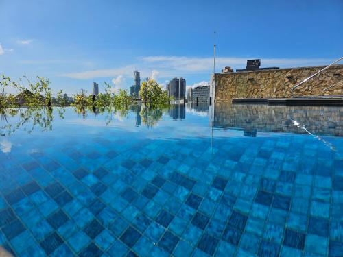 a large pool of water with a city in the background at VAUX Park Street Hotel - A collection of 8 luxury lofts in Colombo