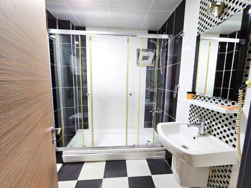a bathroom with a shower and a sink at SAPANCA PARK HOTEL in Sakarya