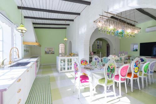 a kitchen with a table with chairs and a dining room at VILLA TOJI luxury private in Bracciano