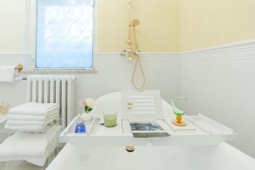 a white bathroom with a sink and a mirror at VILLA TOJI luxury private in Bracciano
