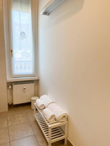 a bathroom with a towel rack and a window at Como view apartment in Como