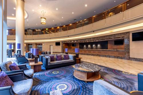 a hotel lobby with couches and a stage at Hilton Tokyo Narita Airport in Narita