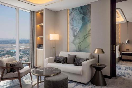 a living room with a couch and a table at Embassy Suites By Hilton Dubai Business Bay in Dubai